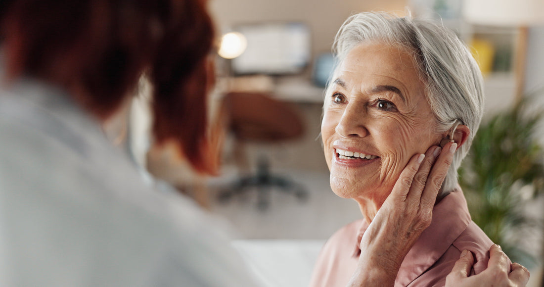 Adult discussing hearing concerns with a hearing care professional at Hear & Now Clinics